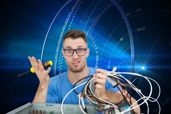 Confused it professional with screw driver and cables in front of ope — Stock Photo, Image