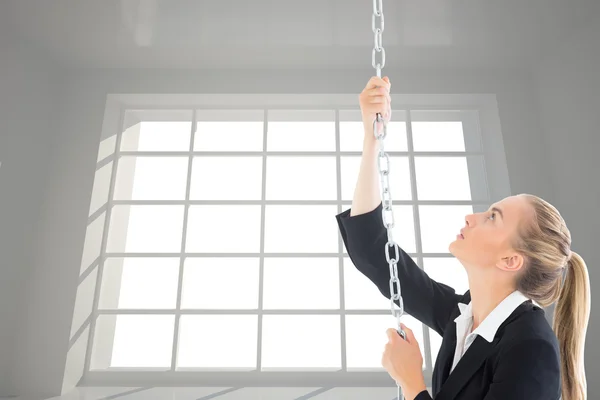 Composite image of businesswoman pulling a chain — Stock Photo, Image