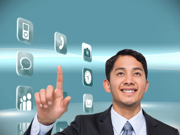 Composite image of smiling asian businessman pointing — Stock Photo, Image