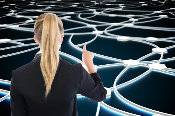 Composite image of business woman pointing somewhere — Stock Photo, Image