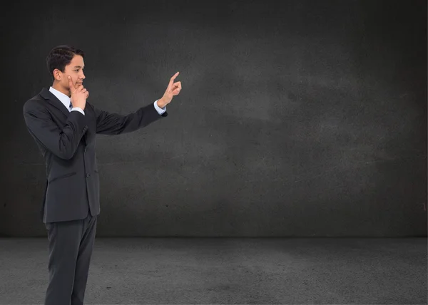 Composite image of thoughtful asian businessman pointing — Stock Photo, Image