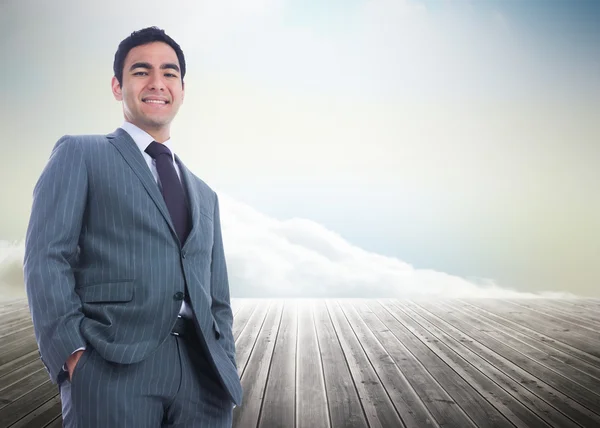 Imagem composta de homem de negócios sorridente de pé — Fotografia de Stock