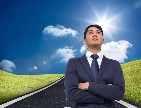 Composite image of unsmiling asian businessman with arms crossed — Stock Photo, Image