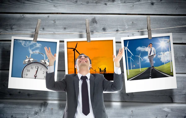Composite image of happy businessman with arms raised — Stock Photo, Image