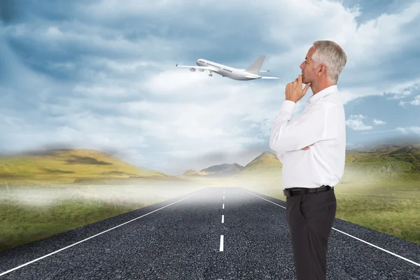 Composite image of thoughtful businessman posing — Stock Photo, Image