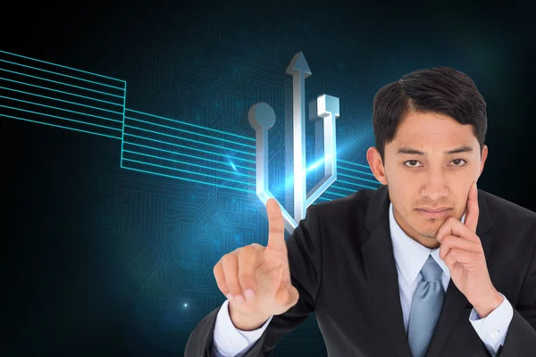 Composite image of thoughtful asian businessman pointing — Stock Photo, Image