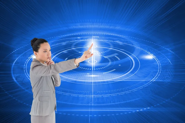 Composite image of thoughtful asian businesswoman pointing — Stock Photo, Image