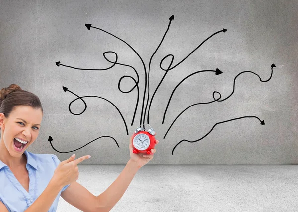 Businesswoman indicating alarm clock — Stock Photo, Image