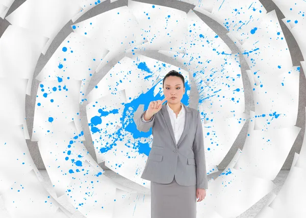 Unsmiling asian businesswoman pointing — Stock Photo, Image