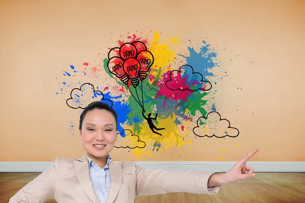 Composite image of smiling asian businesswoman pointing — Stock Photo, Image