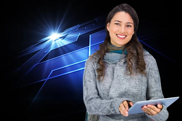 Composite image of smiling model wearing winter clothes holding — Stock Photo, Image