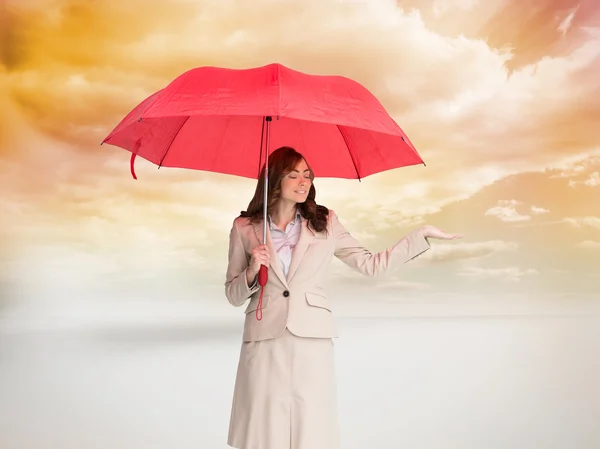 Businesswoman holding red umbrella — Stock Photo, Image