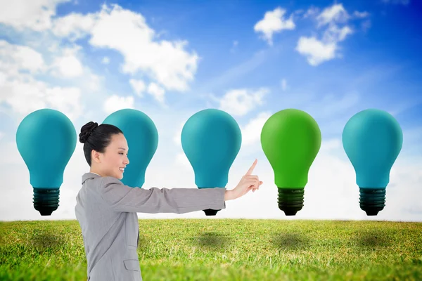 Smiling asian businesswoman pointing — Stock Photo, Image