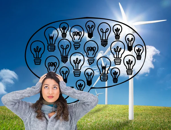 Composite image of anxious pretty brunette wearing winter clothes posing — Stock Photo, Image