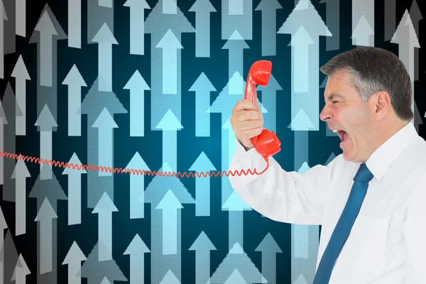 Businessman screaming directly into the handset — Stock Photo, Image