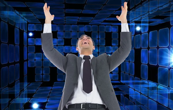 Composite image of excited businessman with arms raised — Stock Photo, Image