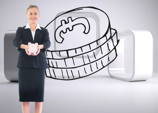 Composite image of happy businesswoman holding a piggy bank — Stock Photo, Image