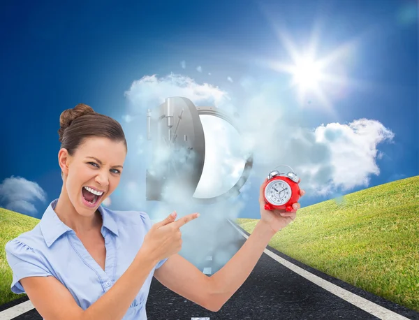 Businesswoman indicating alarm clock — Stock Photo, Image