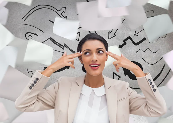 Confident young businesswoman pointing her head with her fingers — Stock Photo, Image