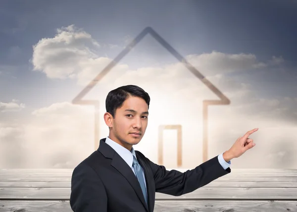Composite image of stern asian businessman pointing — Stock Photo, Image