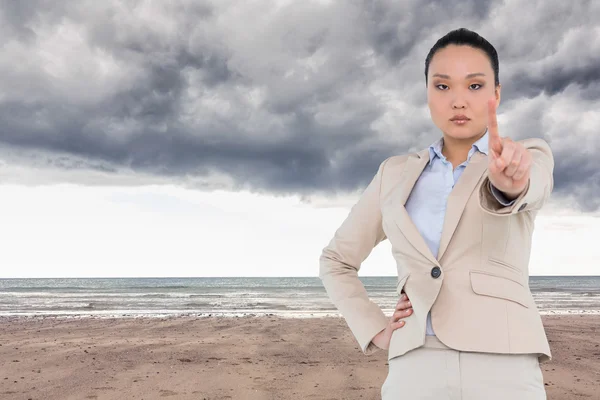 Immagine composita di donna d'affari asiatica non sorridente che indica — Foto Stock