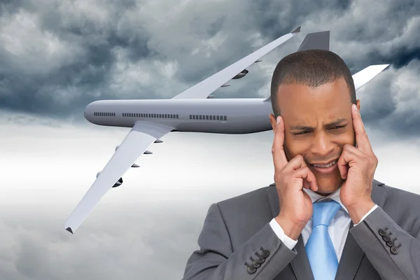 Stressed businessman putting his fingers on his temples — Stock Photo, Image