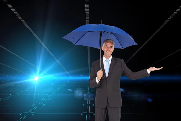 Businessman holding blue umbrella — Stock Photo, Image