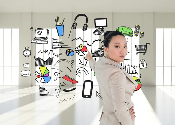 Composite image of unsmiling asian businesswoman pointing — Stock Photo, Image