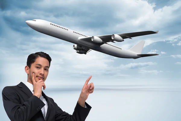 Composite image of thoughtful asian businessman pointing — Stock Photo, Image