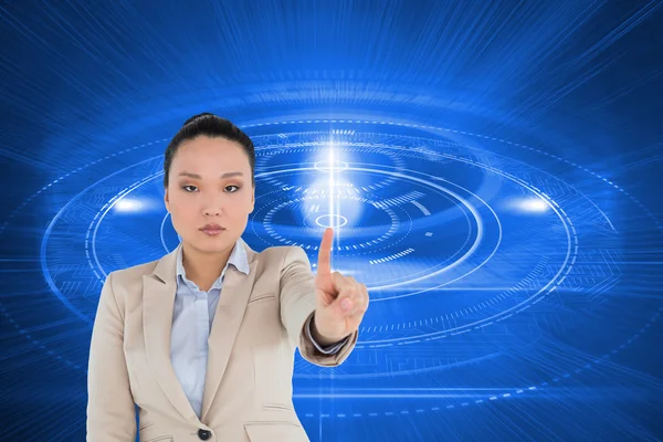 Composite image of unsmiling asian businesswoman pointing — Stock Photo, Image