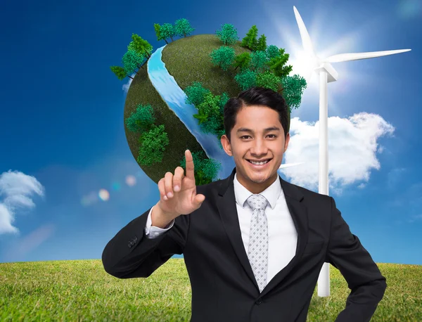 Composite image of smiling asian businessman pointing — Stock Photo, Image