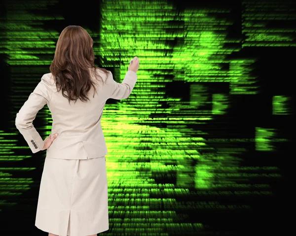 Composite image of businesswoman standing back to camera writing — Stock Photo, Image