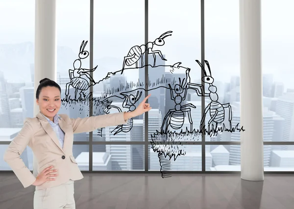 Composite image of smiling asian businesswoman pointing — Stock Photo, Image