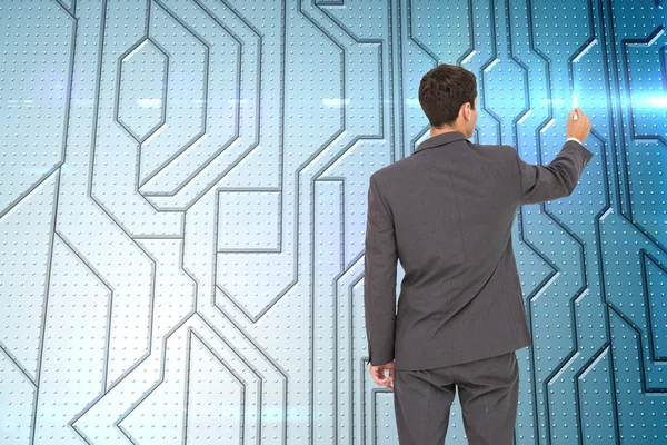 Composite image of businessman standing back to camera writing — Stock Photo, Image