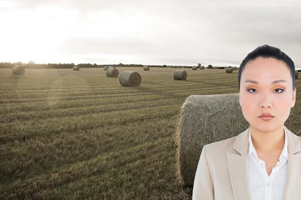 Composite image of unsmiling asian businesswoman — Stock Photo, Image