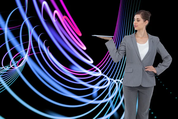 Composite image of businesswoman holding tablet computer — Stock Photo, Image