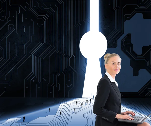 Composite image of businesswoman using laptop — Stock Photo, Image