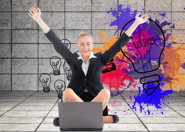 Imagen compuesta de una mujer de negocios sentada frente a un portátil con los brazos en alto —  Fotos de Stock