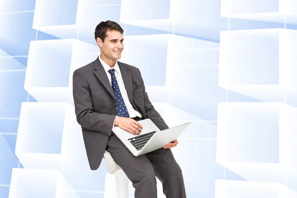 Image composite d'un homme d'affaires utilisant un ordinateur portable — Photo