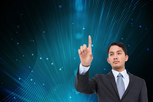 Composite image of serious asian businessman pointing — Stock Photo, Image