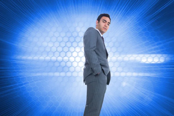 Composite image of unsmiling businessman standing — Stock Photo, Image