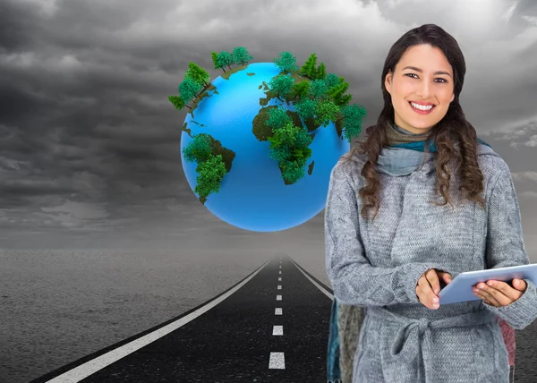 Model wearing winter clothes holding her tablet — Stock Photo, Image