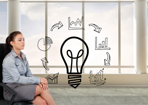 Serious businesswoman sitting on an armchair — Stock Photo, Image