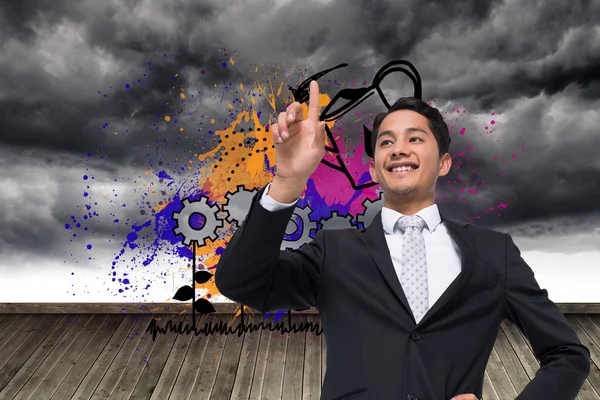 Composite image of smiling asian businessman pointing — Stock Photo, Image