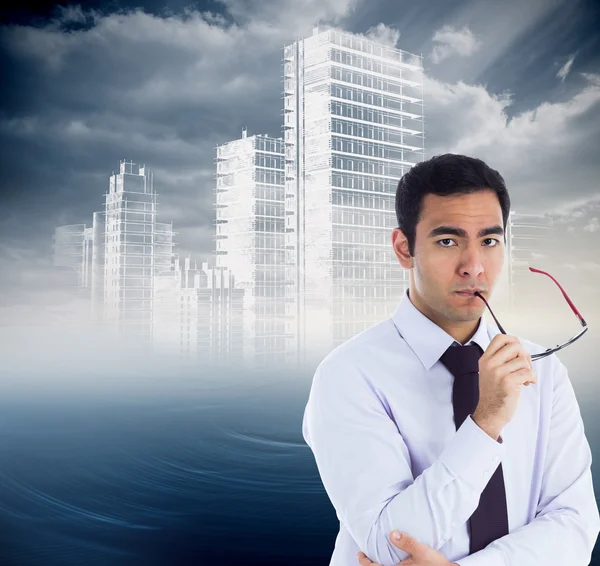 Composite image of unsmiling businessman holding glasses — Stock Photo, Image