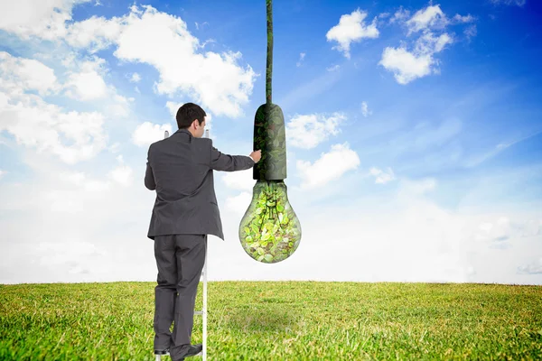 Composite image of businessman standing on ladder — Stock Photo, Image