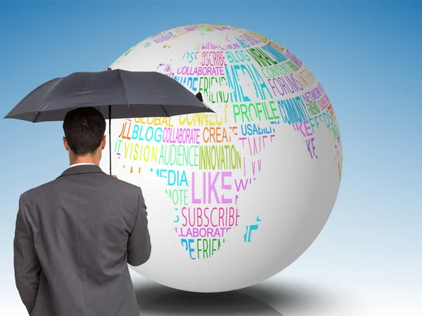 Composite image of rear view of classy businessman holding grey umbrella — Stock Photo, Image