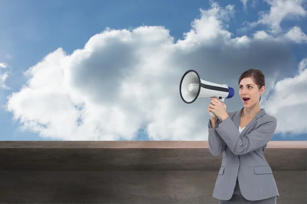 Composite image of businesswoman with loudspeaker — Stock Photo, Image