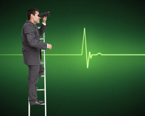 Businessman standing on ladder holding binoculars — Stock Photo, Image