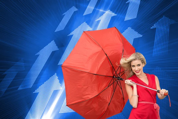 Composite image of smiling blonde holding umbrella — Stock Photo, Image